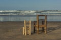 Rear view small wicker chairs stand up in the seashore Royalty Free Stock Photo