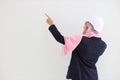 Rear view smart engineering muslim young asian woman wearing blue suit with confident, pointing and using mobile phone in studio.