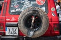 Rear view of a spare wheel and shovel of an old red Mitsubishi Montero Pajero SUV