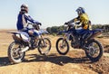Rear view, sport or racer on motorcycle outdoor on dirt road with relax after driving, challenge or competition