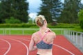 Rear view of sprinter massaging her own neck Royalty Free Stock Photo