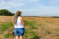 Rear view of standing adult female hiker watching agricultural landscape Royalty Free Stock Photo