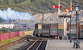 Rear view of steam locomotive Blanche pulling out of the Ffestiniog Railway station under signals, Porthmadog, Gwnydd, Wales Royalty Free Stock Photo