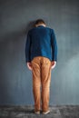 Rear view of stressed man punching the wall Royalty Free Stock Photo