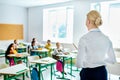 rear view of teacher looking at children