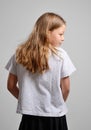 Rear view of the teenage girl concealing something Royalty Free Stock Photo