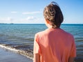 Rear view of a teenager boy on the beach Royalty Free Stock Photo