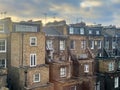 Rear view of terraced brick houses in Kensington, London, at sunrise