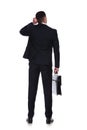 Rear view of thinking businessman holding briefcase Royalty Free Stock Photo