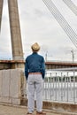 Rear view of thoughtful man, businessman looking at cityscape and river while standing outdoors. Royalty Free Stock Photo