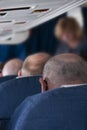 Three bald men in passenger aircraft