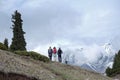 Rear view of three people in mountains in early spring near Almaty city, Kazakhstan