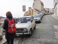 Rear view of tourist woman sightseeing discovering Portuguese street view in