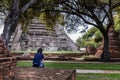 Rear view of Tourist woman is sitting alone sit rest at Wat Ratchaburana
