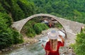Rear view of tourist woman watch the famous senyuva cinciva stone bridge on the storm valley Firtina vadisi, Rize, Turkey
