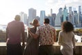 Rear View Of Tourists Looking At Manhattan Skyline