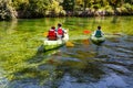 Kayaking, canoeing, paddling.Tourists paddling kayaks down the river Sorgue in Fontaine-de-Vaucluse. France.