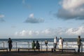 tourists sitting on the bench in front of Gold Coast Beach Australia