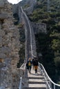 Rear view of tourists walking on stairs of the Medieval city walls near Ston, Croatia