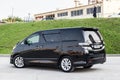 Rear View of Toyota Vellfire japanese luxury minivan car in black color on the parking with seven passenger seats Royalty Free Stock Photo