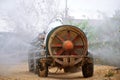 Rear view of Tractor spraying pesticide and insecticide on lemon plantation in Spain. Weed insecticide fumigation. Organic