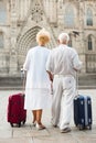 Rear view of traveling mature spouses Royalty Free Stock Photo