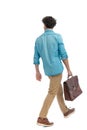 rear view of turkish man with curly hair holding suitcase and walking Royalty Free Stock Photo