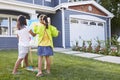 Rear View Of Two Girls Painting Picture In Garden Royalty Free Stock Photo