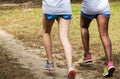 Rear view of two girls running on a dirt path side by side Royalty Free Stock Photo