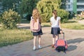 Rear view, two little girls schoolgirls going to school with backpacks Royalty Free Stock Photo