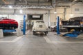 Rear view on two Russian classic vintage cars gaz m20 pobeda and 13 chaika and modern sportcar marussia in a repair shop in good