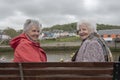 Two senior woman sitting on a park bench outdoors Royalty Free Stock Photo