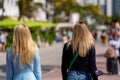 Rear view of two women with blond hair on blurry background