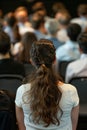 Rear view of unidentifiable audience members at business and entrepreneurship symposium