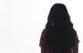 Rear view of unrecognisable young woman with long dark hair back turned to camera facing away. Isolated white background Royalty Free Stock Photo