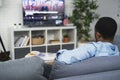 Rear view of black man watching USA election on TV Royalty Free Stock Photo