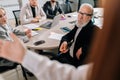 Rear view of unrecognizable female speaker talking to team on corporate briefing, giving seminar, workshop, answering Royalty Free Stock Photo