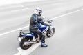 view of unrecognizable man motorbiker wearing protective high-tech suit riding a moder sport motorcycle