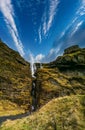 Rear view of unrecognizable tourists looking at hidden waterfall Royalty Free Stock Photo