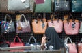 Rear view of unrecognizable woman shopping bags