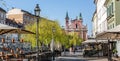 Rear view of unrecognizable woman walking a dog in empty old medieval Ljubljana city center during corona virus pandemic