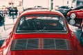 Rear view of vintage red car parked in garage Royalty Free Stock Photo