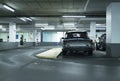 Rear view of vintage sports car on parking lot of garage. Royalty Free Stock Photo