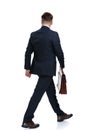 Rear view of a walking businessman holding his briefcase Royalty Free Stock Photo
