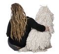 Rear view of a White Corded Poodle and a girl