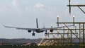 Twin engine airplane lands on illuminated runway Royalty Free Stock Photo