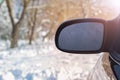 The rear view window is covered with hoarfrost, against a background of soft focus.