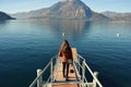 Rear view of a woman alight on Lake Como pier in Italy