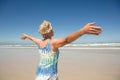 Rear view of woman with arms outstretched standing against clear sky Royalty Free Stock Photo