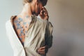 Rear view of a woman with a bare wall, blue hydrangea flower petals on her tanned skin. Royalty Free Stock Photo